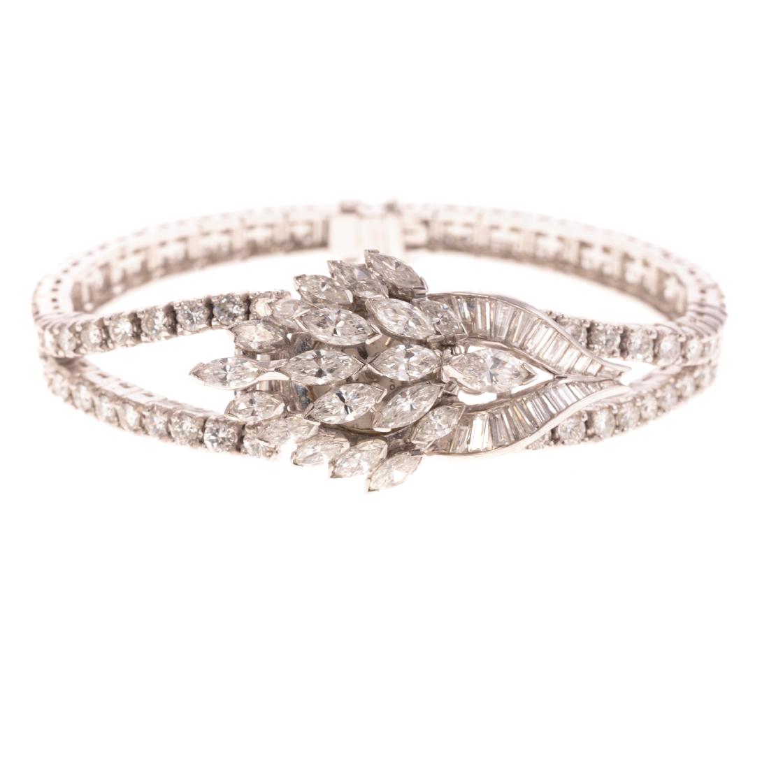 A Diamond Covered Dress Watch by Omega in Platinum: Platinum covered dress watch by Omega featuring 21 marquise cut diamonds, 20 baguettes and 116 full cut diamonds weighing approx. 12.00 ctw, spring hinge design to reveal the round face, mechanical mo