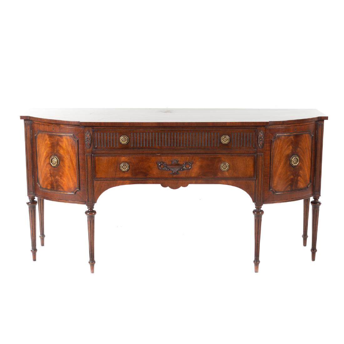 George III Style Carved Mahogany Sideboard: early 20th century, breakfront top, two long drawers, flanked by cabinet doors on rounded fluted legs, 36 in. H., 72 in. W., 23 1/2 in. D.