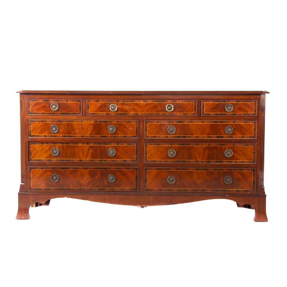 George III Style Mahogany Inlaid Dresser: 20th century, rectangular top with stringer inlay and rosewood banding, canted corners with fluting, three over six graduated drawers, shaped apron, bracket feet, 30 1/2 in. H., 59 3/4 in. L., 18 in. 