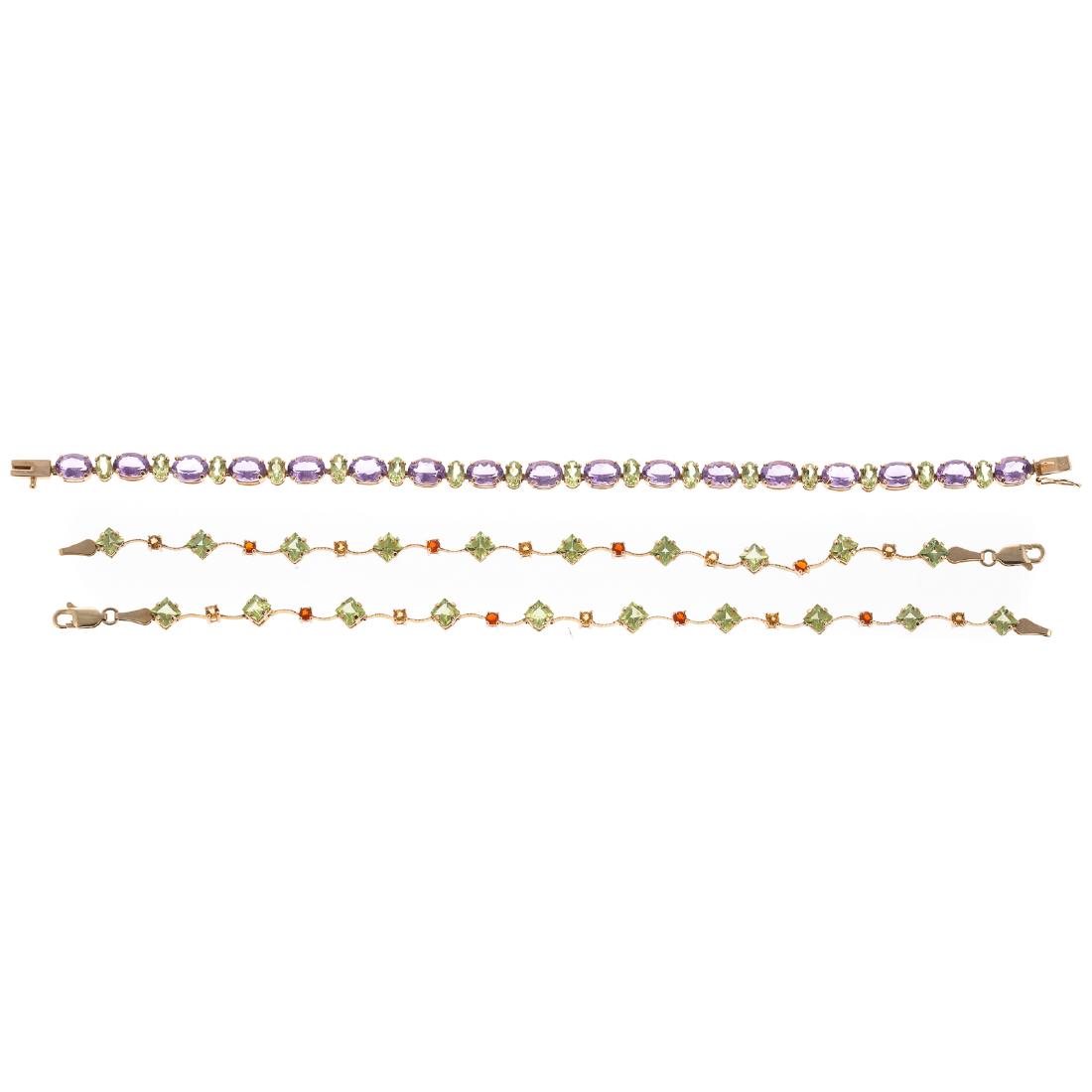 A Trio of Ladies Gemstone Link Bracelets in Gold: 1) 14K yellow gold link bracelet with oval amethyst alternating with oval peridots, hidden box clasp with figure 8 safety, 7.5 in. L and 2) Matched pair of 14K yellow link bracelet featuring yellow an