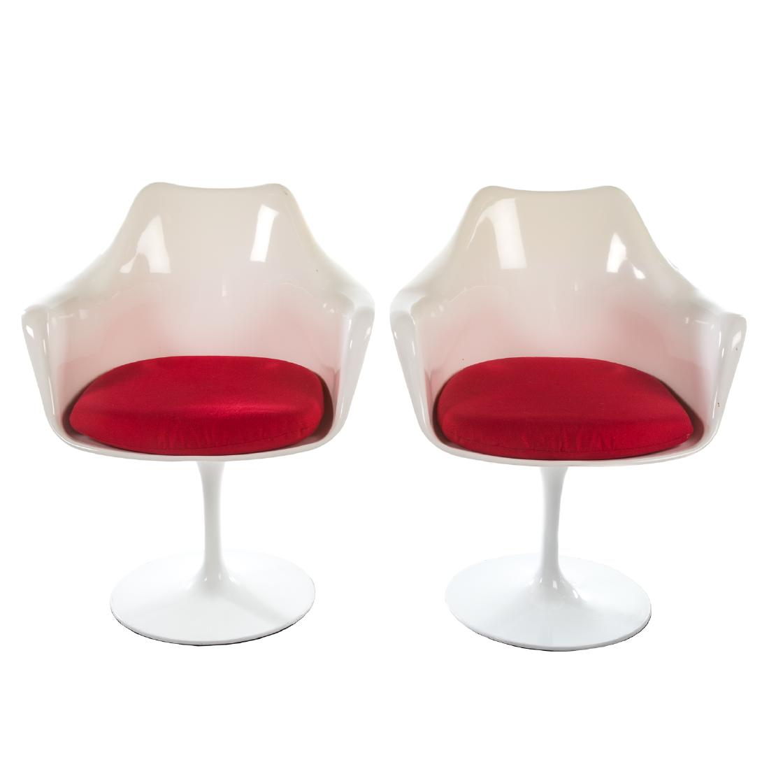 Two Eero Saarinen Style Tulip Arm Chairs: 20th century, white molded fiberglass seats with upholstered cushions on enameled aluminum bases; 33 in. H., 26 3/4 in. W., 22 in. D.
