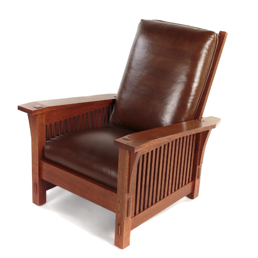 L & G Stickley Oak Morris Chair: 20th century, adjustable ladder back, wide plank arms with exposed through-tenons and banister sides, squared legs, loose green leather back and seat cushions, 39 1/2 in. H., 32 3/4 in. W.,. 37 1/2 in
