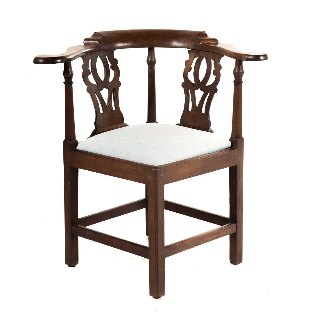 George III Walnut Corner Chair: England, fourth quarter 18th century, yoke form crest rail, pair of pierced splats and three turned supports, slip seat on straight Chippendale legs connected by stretchers; 32 in. H., 31 in. W., 24 i