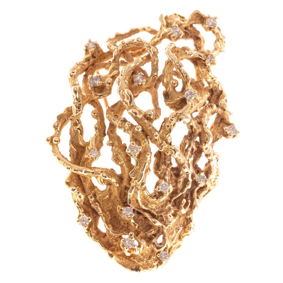A 14K Organic Freeform Diamond Pin by C. Hopkins: 14K yellow gold organic freeform pin by Charles Hopkins, Chapel Hill, NS featuring 16 diamonds set throughout the brooch, textured finish gold, 2.25 in. L, 33.5 grams tw; The Estate of Ann Robinson, N