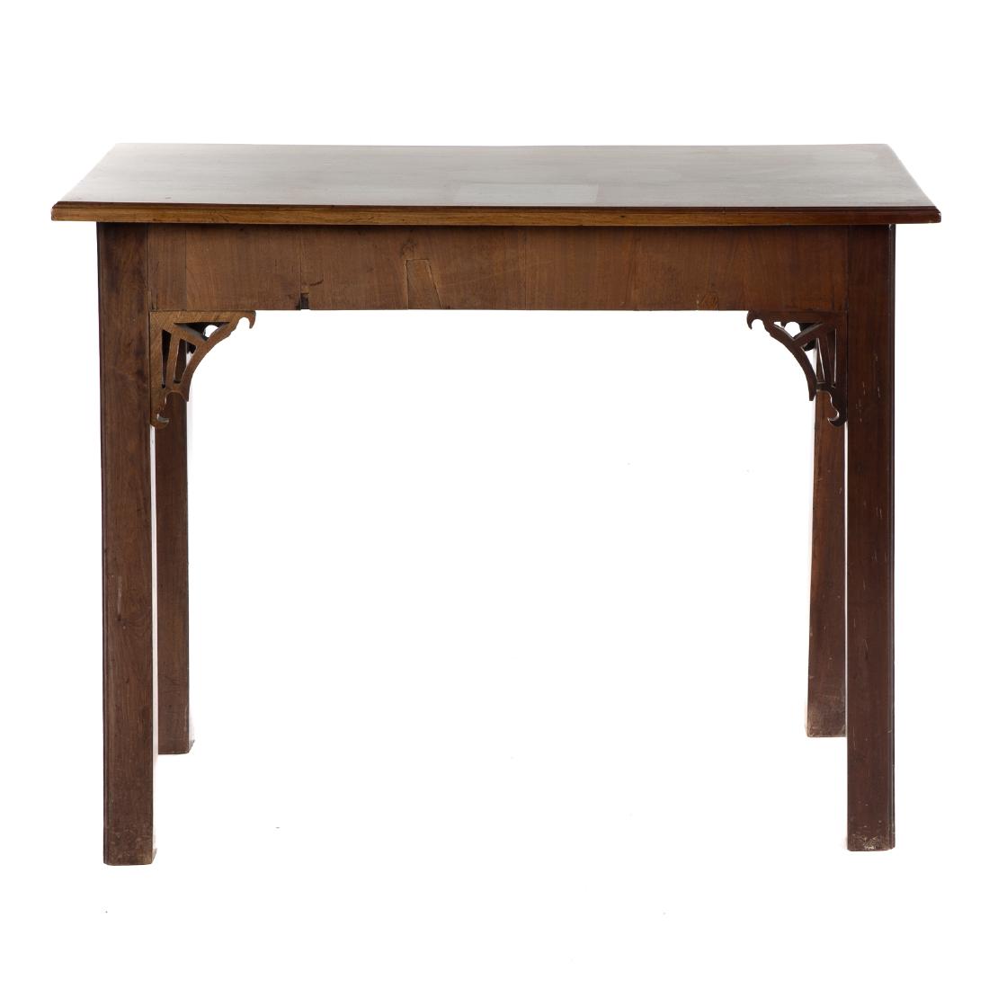 George III Chinese Chippendale Mahogany Side Table: 18th century, flat top with molded edge, 4 in. veneered apron, pierced spandrels, straight legs; 30 in. H., 39 in. W., 20 in. D.