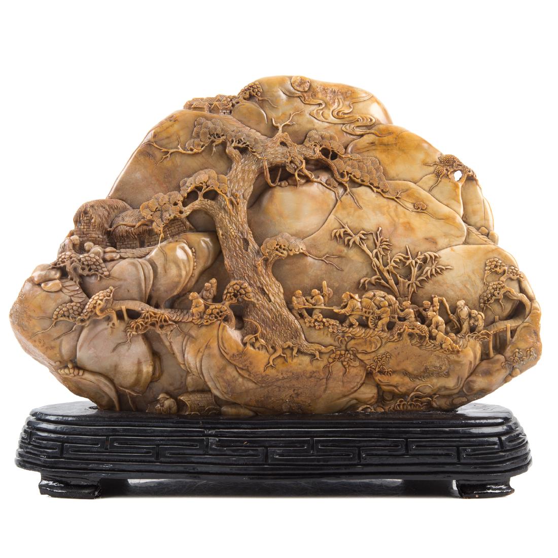 Chinese Carved Soapstone Mountain & Travellers: elaborately carved village and figural relief decoration on both sides, character marks underneath, 9 in. H., 12 in. W., on ebonized wood fitted stand