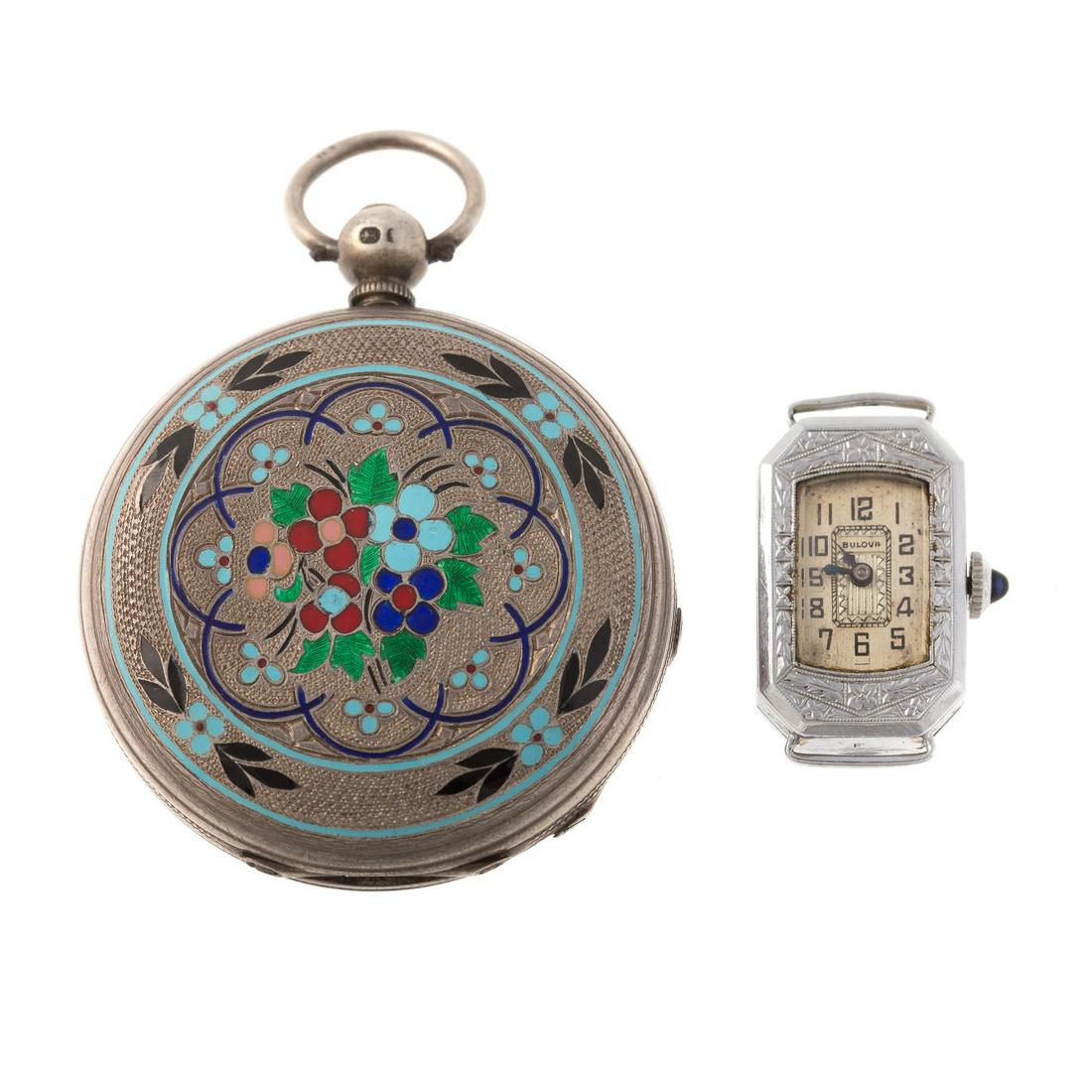 A Vintage Enamel Pocket Watch & Ladies Bulova: 1) English, silver pocket watch featuring multi colored enamel royal blue enamel adorned with snowflake, Roman numerals, subdial, key wind, 1.90 in. D, and 2) silver ladies vintage Bulova watch case, 