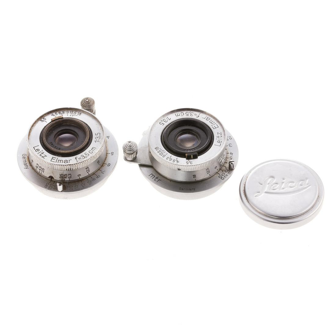 Two Leica Elmar Lenses: dated 1948; 1:3,5, serial # 654860, with stamped aluminum Leica lens cover and similar lens 1:3,5, serial # 678190