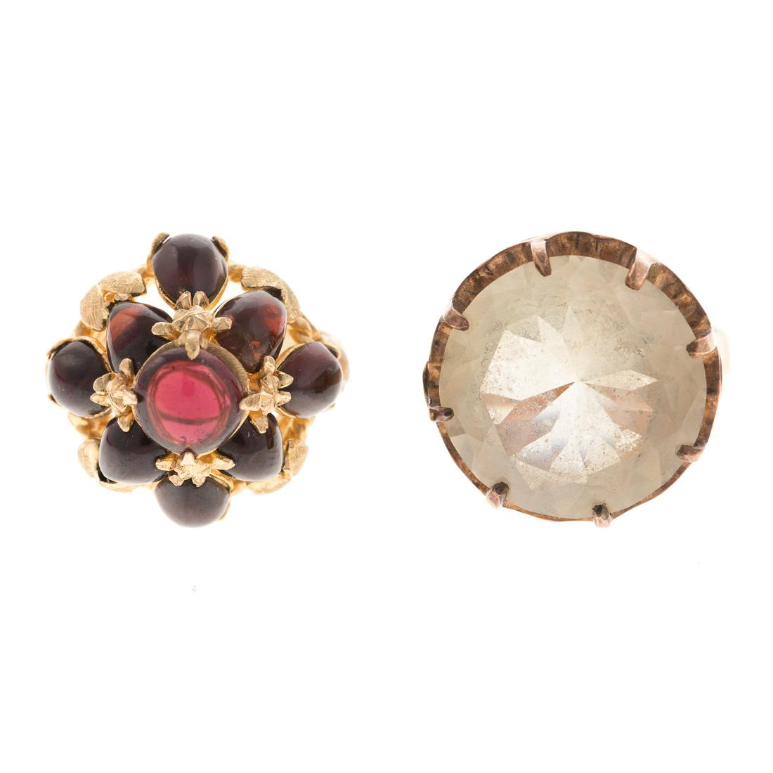 Two Ladies Vintage Gemstone Rings in 14K Gold: 1) 14K yellow gold bombe ring featuring 8 cabochon garnets in vivid dark brownish/red weighing approx 5.15 ctw, sz 6.5, and 2) 14K yellow gold modified round brilliant cut smoky quartz measuring appro