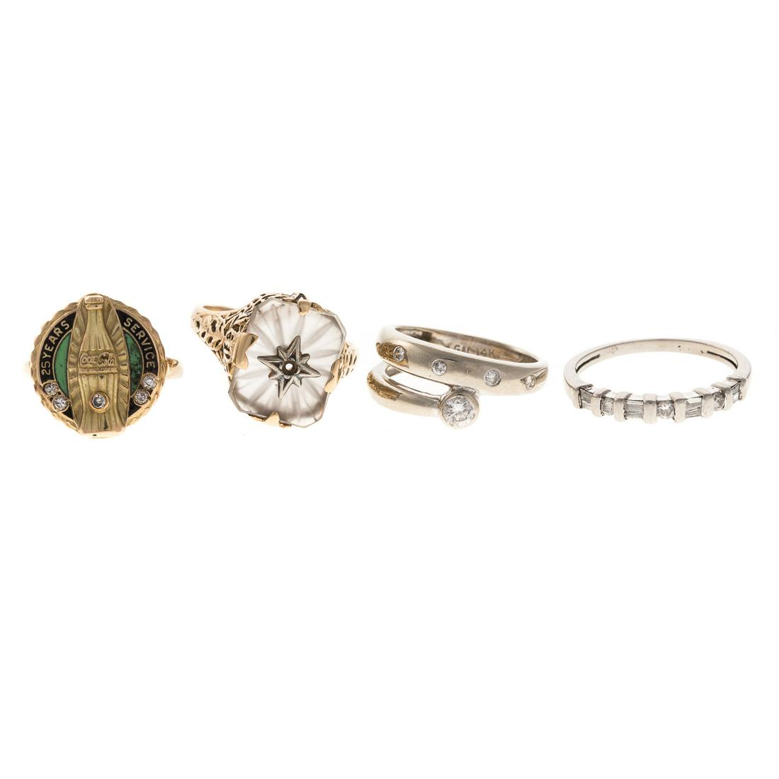 A Collection of Rings in Gold with Diamonds: 1) 14K white gold bypass ring with bezel and flush set diamonds, sz 4, 14K yellow gold filigree ring with cushion shape carved crystal in center, sz 5.25, 3) 14K yellow gold enamel 25 year Coke Cola s