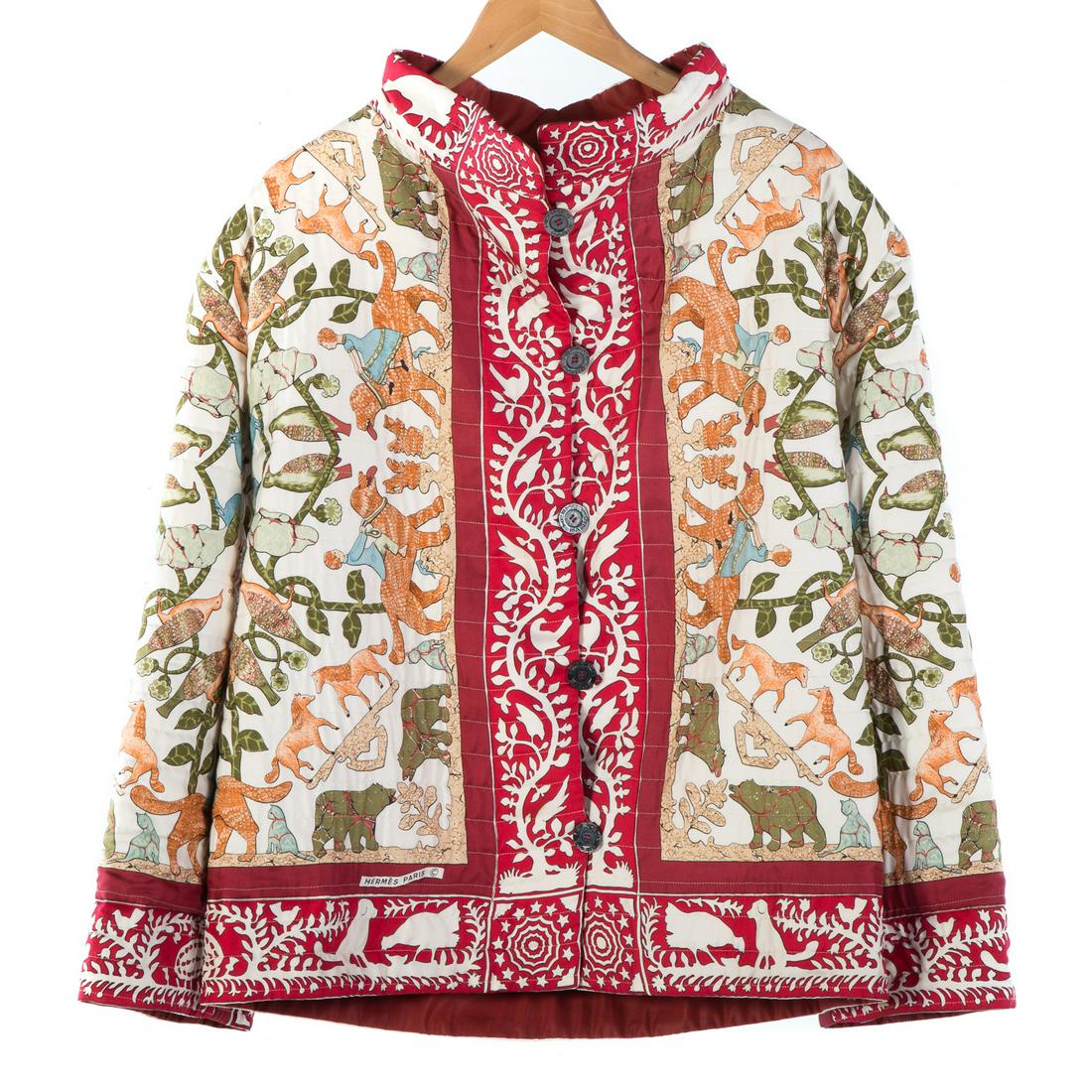 A Vintage Hermes Quilted Silk Jacket: Red and multi-color Hermes reversible silk jacket, featuring “Early America” motif with two panels of Hermes engraved buttons and quilted stitching, measuring bust: 20" and length: 28".