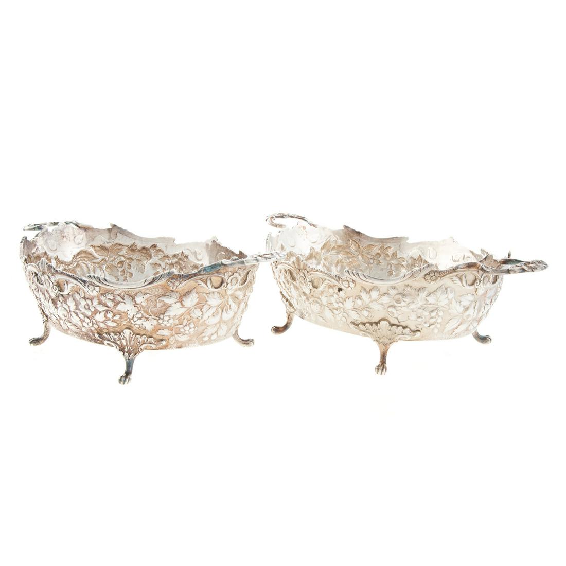Pair of A. E. Warner Sterling Silver Footed Dishes: Mid-19th century, Baltimore, 11-2 sterling mark, oval with fruit and floral repousse decoration, interior with "MEA" monogram, within wreath and surrounded by hand chased decoration, raised on 4 paw f