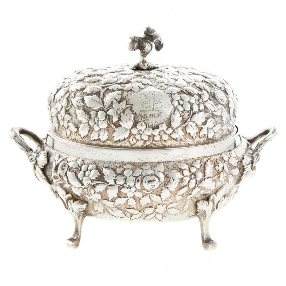 A. E. Warner Silver Repousse Butter Dish: Mid-19th century, Baltimore, silver standard mark partially rubbed but probably sterling, round, interior fitted with pierced insert, dome cover with foliate finial and armorial crest with "AMB" monog
