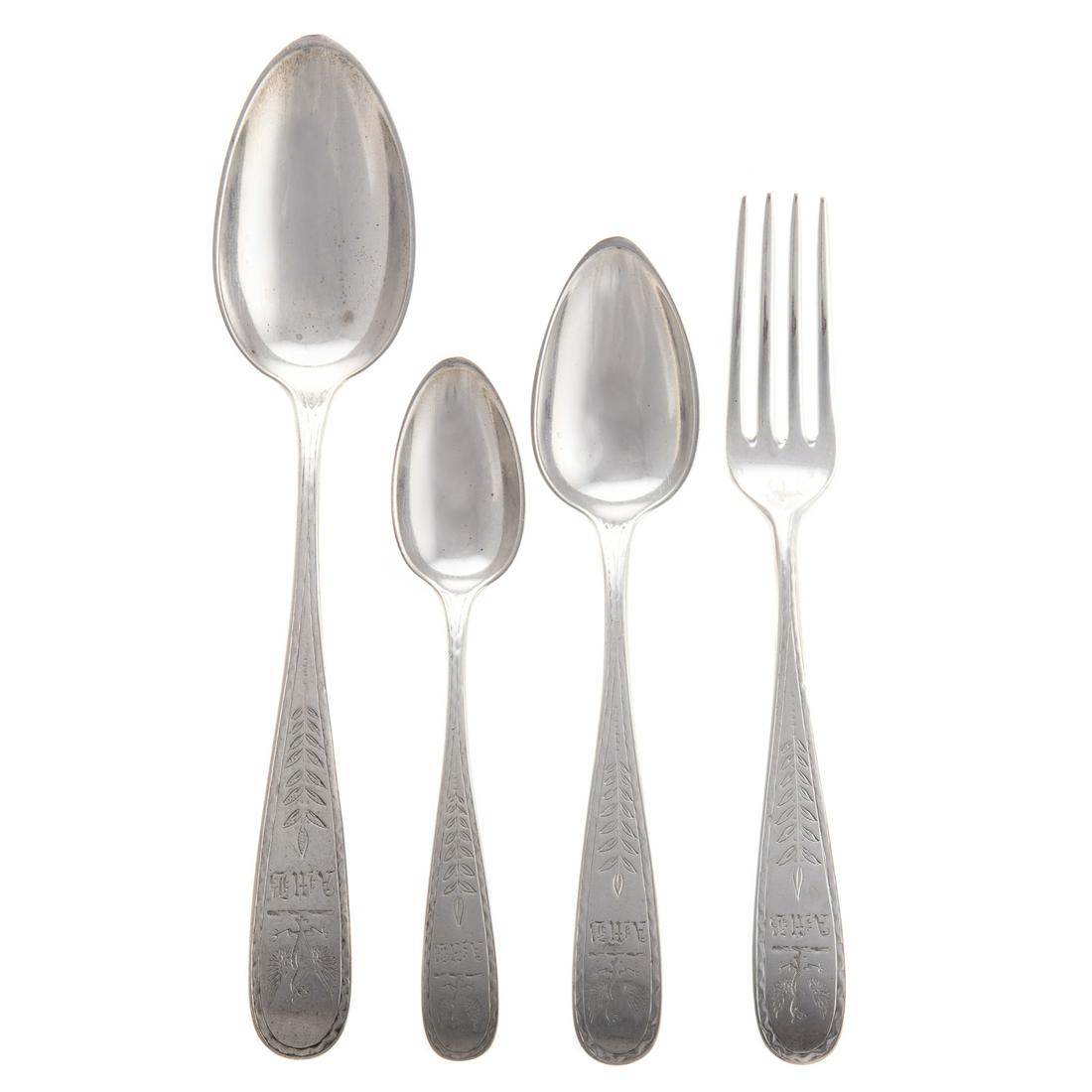 A. E. Warner Coin Silver Partial Flatware Service: including 16 dinner forks, 11 dinner spoons, 10 teaspoons, 12 large scale serving/dinner spoons, each with armorial crest and "AMB" monogram, 76.55 ozt.