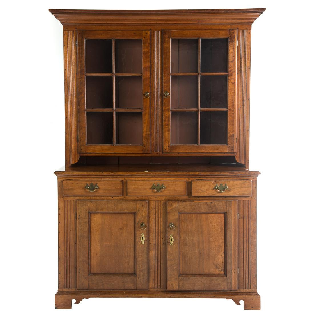 Federal Walnut Step-back Cupboard: New Jersey/Pennsylvania, late 18th century, upper case with flat molded cornice, compartment with shelves enclosed by double glass panel doors, fluted stiles, open shelf beneath, lower case with three