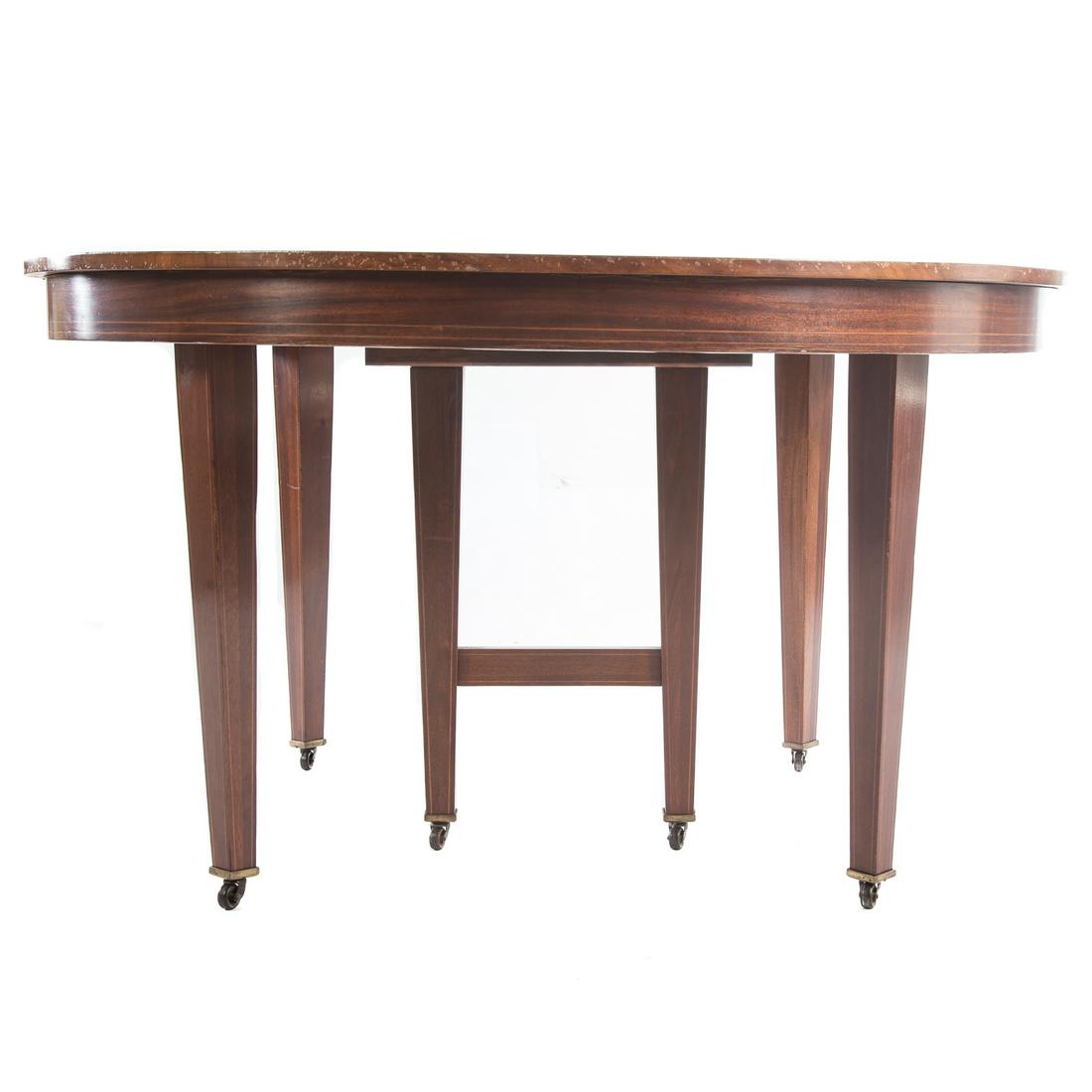 Federal Style Mahogany Dining Table: Early 20th century; two 26 1/2 " half round ends, straight tapered legs with roller casters, double legged middle support for four extension leaves, 30 in. H.