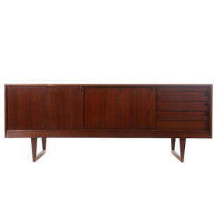 Povl Dinesen Mid-century Modern Teak Credenza: mid-20th century; compartment with shelves enclosed by sliding panel doors flanking compartment with four medium drawers, straight tapered legs connected by trestle stretcher, 32 in. H, 83 1/2 W., 21