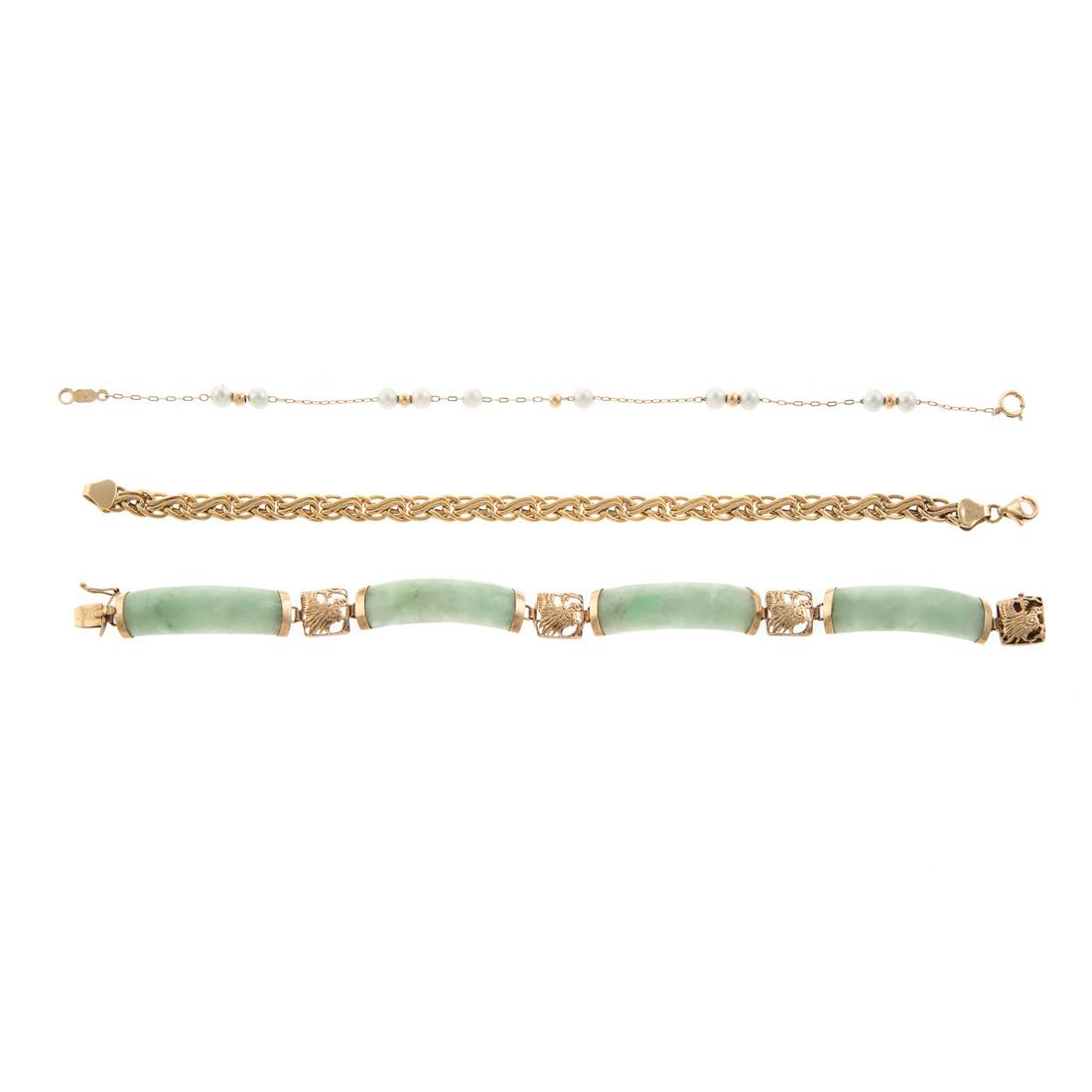A Trio of 14K Pearl & Jade Link Bracelets: 1) 14K yellow gold woven link bracelet, lobster clasp, 0.25 in. W, 7.25 in. L, 2) 14K yellow gold pearl and gold bead station bracelet, spring ring clasp, 7.25 in. L and 3) 14K yellow gold jade links