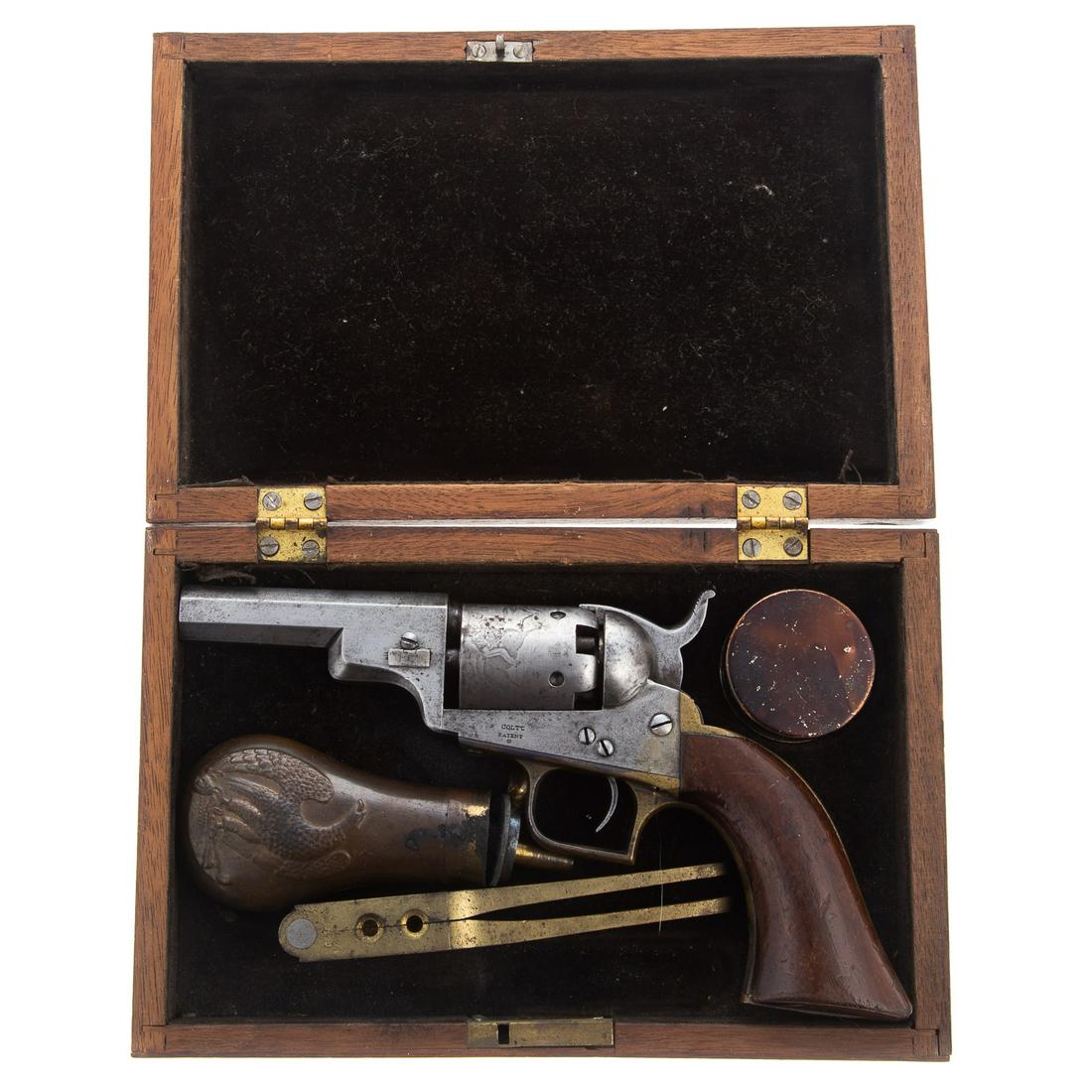 Colt Baby Dragoon Percussion Revolver: Cylinder has cowboy chasing Indians engraved scene. Serial#'s match in 5 places of 1212, wedge marked 212, 3" octagonal barrel. Comes with case, Colt marked bullet mold, powder flask and tin of caps.