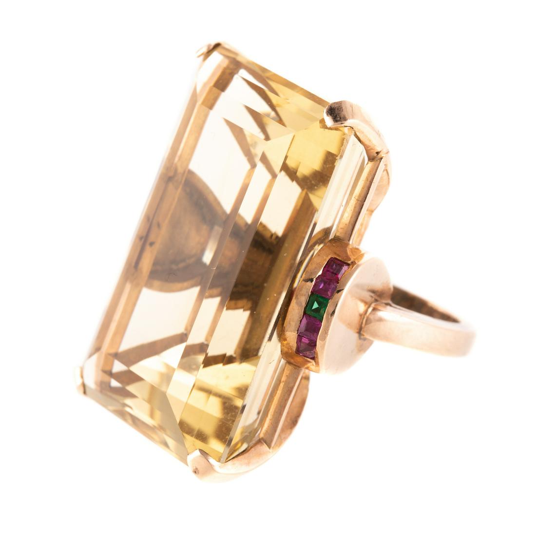 A Retro Citrine Ring with Rubies in 14K: 14K rose gold setting features a bold emerald cut citrine weighing approx. 94 cts, on each side of the citrine are square cut rubies and an emerald, hand engraved message inside the shank, sz 5, 38.9 