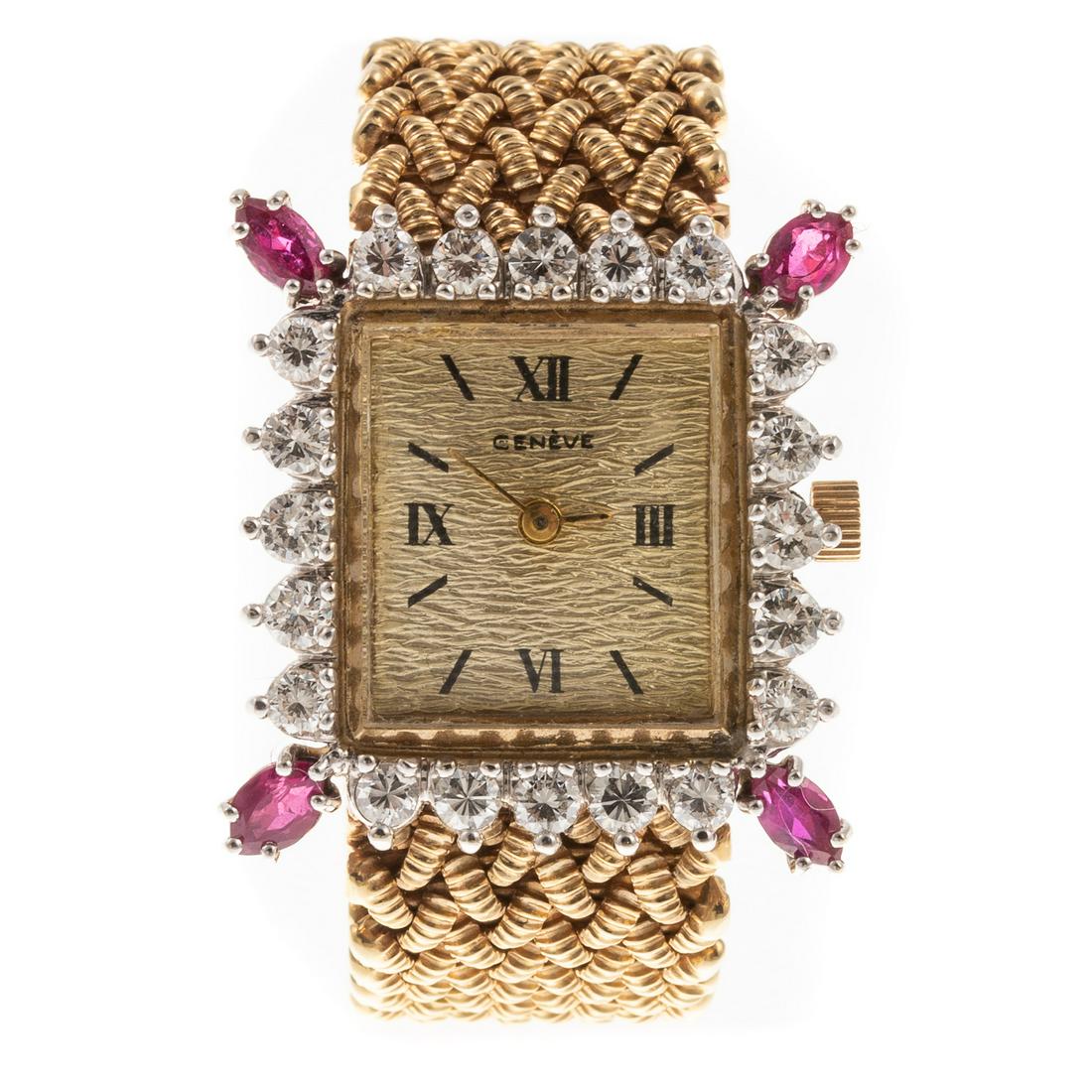 A 14K Diamond & Ruby Geneve Cocktail Watch: 14K yellow gold watch by Geneve with square gold toned face with 20 round full cut diamonds weighing approx. 1.25 ctw and 4 navette shaped rubies set at the corners, mesh bracelet with monogrammed fol