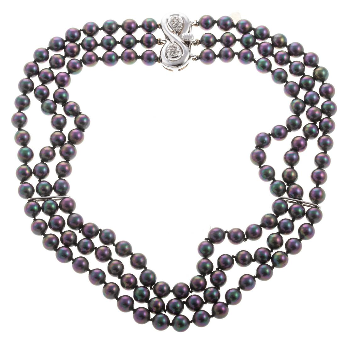 A Tahitian Three Strand Pearl Necklace in 18K: 18K white gold necklace featuring three strands of Tahitian pearls measuring approx. 7 mm each, two white gold bar stations, hidden box clasp with figure eight motif with pave diamonds, shortest stran