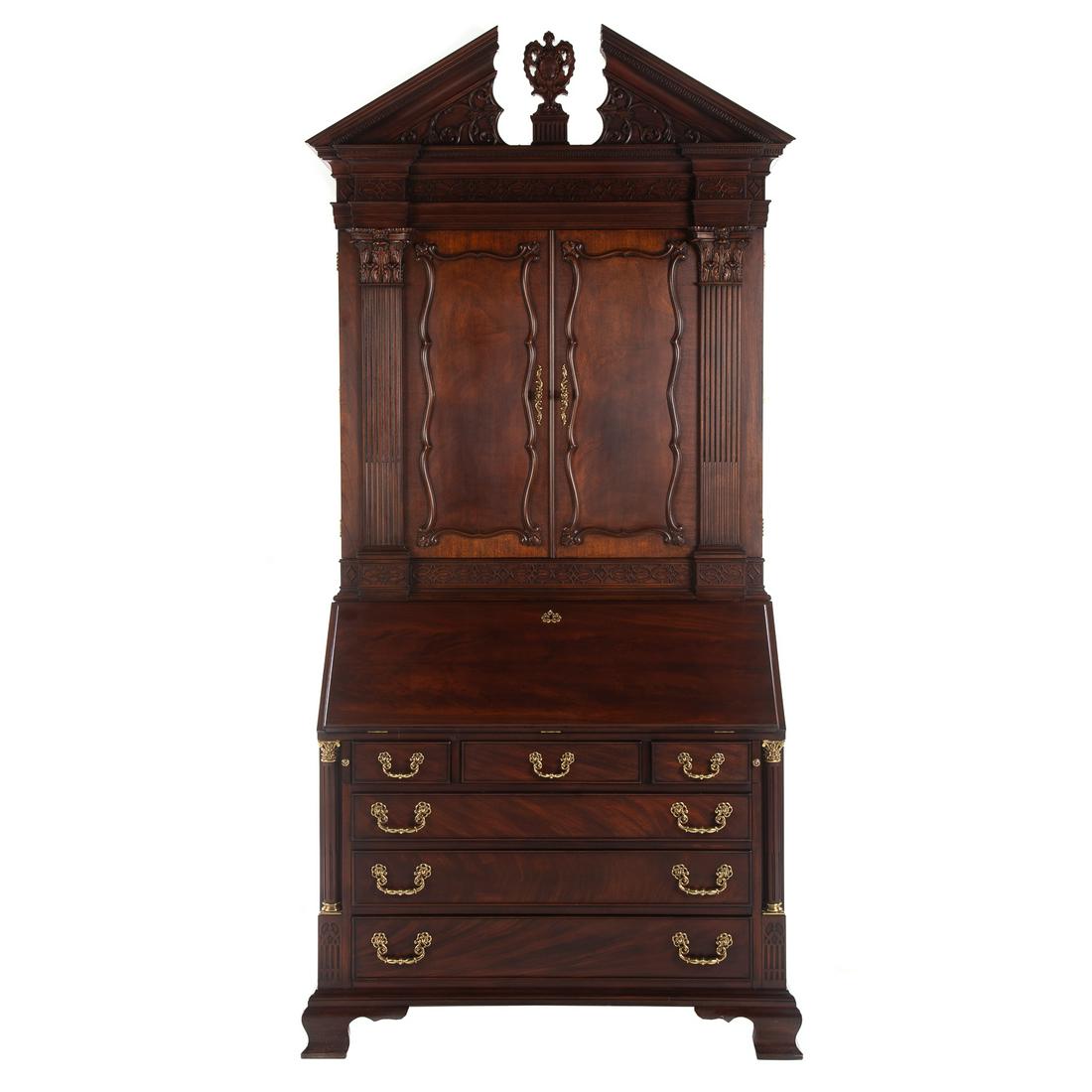Henkel Harris Document Secretary Bookcase: Circa 1999; Georgian style mahogany desk, with top case having broken arch pediment, double panel doors open to reveal elaborate fitted interior, bottom case with fall front door housing elaborate fit