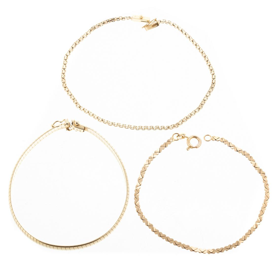 A Trio of Gold Link Chains in 14K: 1) 14K yellow gold Omega bracelet, made in Italy, hidden box clasp with two safety latches, 7 in. L., 2) 14K yellow gold double heart link bracelet, made in Italy, spring ring clasp, 7.25 in. L., and 