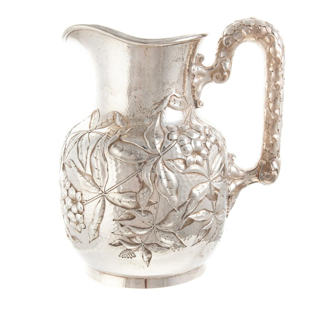 Dominick & Haff Sterling Pitcher: 1886 date mark, retailed Shreve, Crump and Low; in the Aesthetic Movement taste, hammered surface with lush repousse foliage allover, the handle with applied foliage allover, 9 in. H., 34.30 ozt.