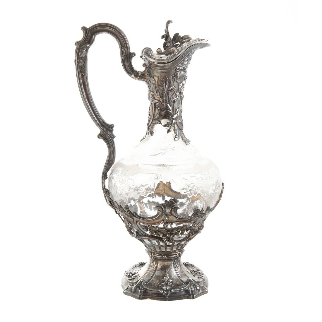 French Silver-Mounted Crystal Wine Ewer: Emile Puiforcat, Paris, 950 silver standard; shaped foot, with applied shell and trailing flowers, surmounted with basket-weave support, with grape swags and scrolling decoration, containing a crystal