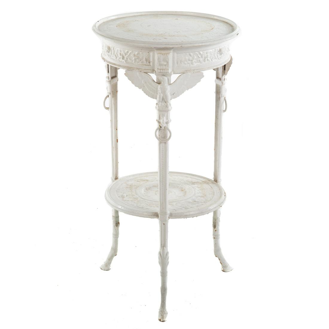 Renaissance Revival Wrought Iron Plant Stand: Circa 1870; circular stand, with eagle supports, stretcher shelf, ending in hoof feet. 29 in. H., 15 in. Diam.
