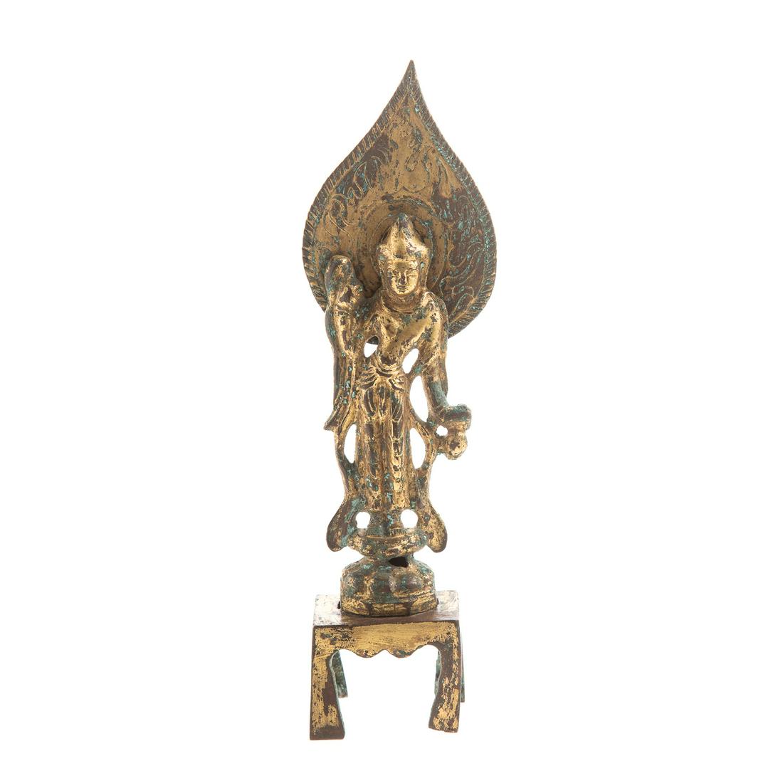 Small Thai Gilt Iron Shrine: 19th century or earlier; standing female figure, with removable halo, attached to four legged table stand, 7 in. H.