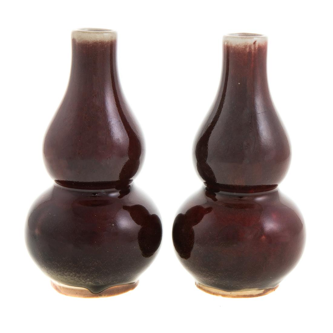 Pair Chinese Sang de Boeuf Porcelain Vases: 19th century; double gourd vases, 5 1/2 in. H. From the Estate of Philip S. Dubey.