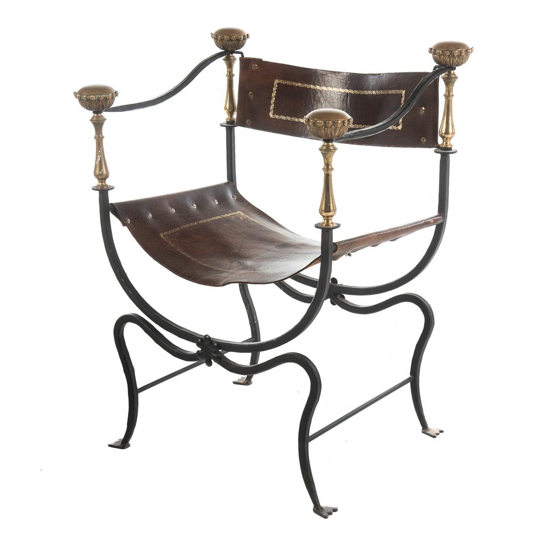 Campaign Style Brass & Iron Throne Chair: Circa 1920; attributed to Oscar Bach, with forged iron frame, with polished brass turrets, tooled leather seat and backing. 30 in. H., 23 in. W., 18 in. D.
