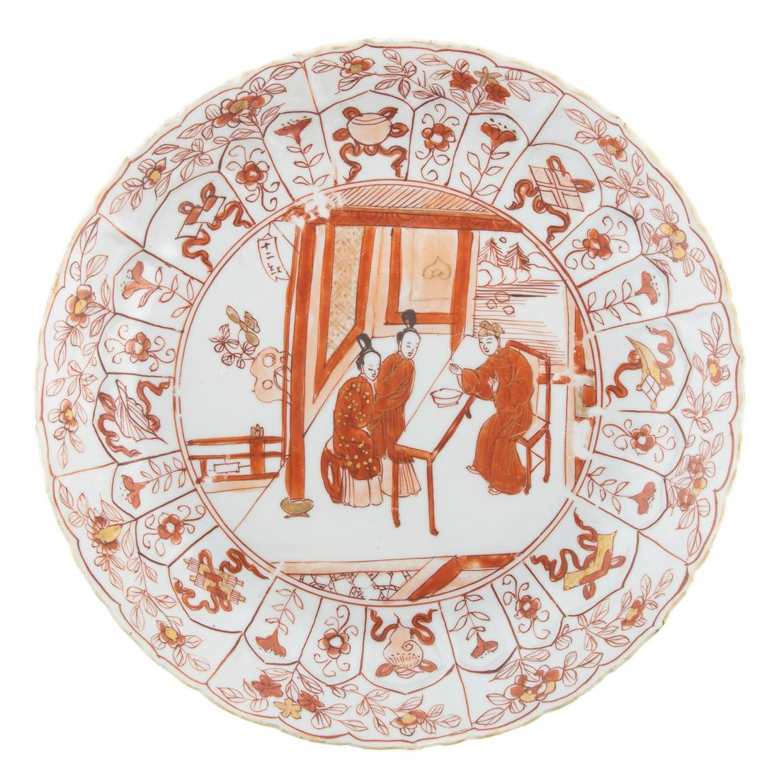 Chinese Export Rouge De Fer Plate: Kang Xi circa 1690-1710; molded plate to resemble flower, having paneled border with floral decoration and center court scene, 8 1/2 in. Diam. From the Estate of Philip S. Dubey.