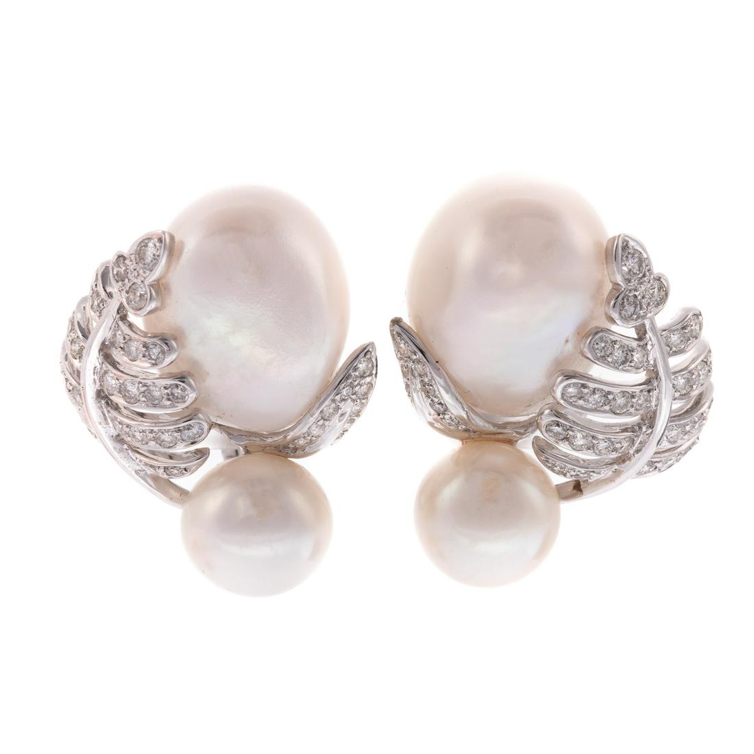 A Pair of Pearl & Diamond Leaf Ear Clips in 18K: 18K white gold ear clips feature baroque South Sea pearls, measuring approx. 14.31 x 17.82 x 11.15 mm, surrounded by two leaf motifs bead set with round cut diamonds, weighing approx. 1.00 ctw, with a