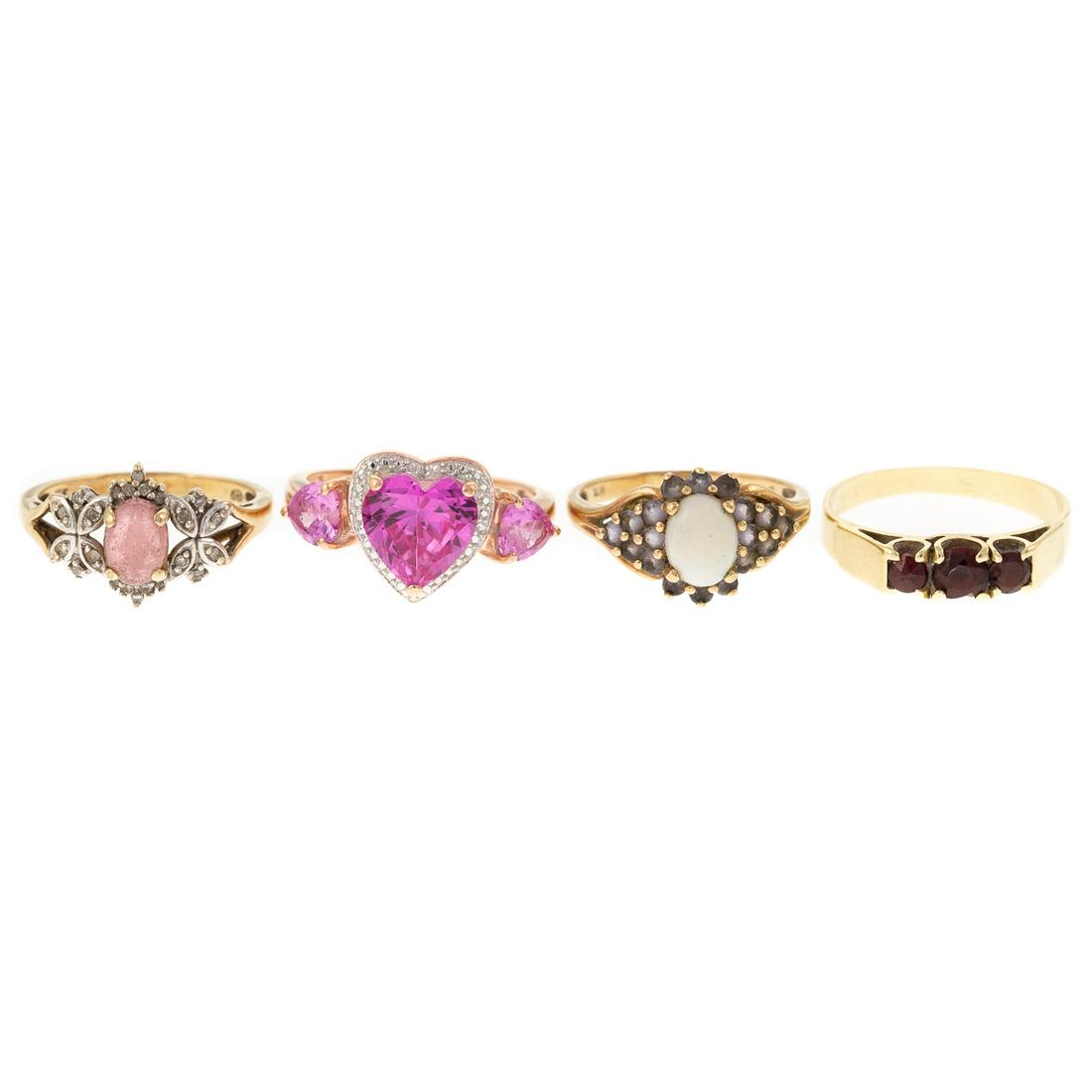 A Collection of Rings in 14K & 10K: 1) 14K yellow gold band with three prong set round cut garnets, sz 7.75, 2) 10K yellow gold ring with oval opal and synthetic stones, sz 7.25, 3) 10K rose gold ring with pink synthetic stones, sz 8.25