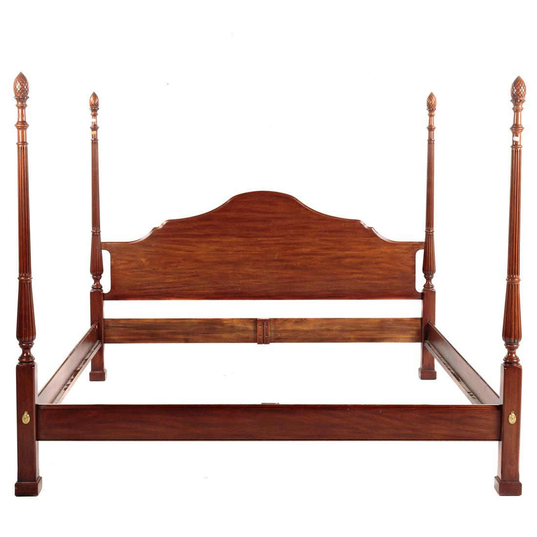 Henkel Harris Mahogany King-Size Poster Bed: Circa 1993; solid mahogany with shaped headboard, having carved and fluted posts, with carved pineapple finials. Headboard 46 in. H., posts 68 in. H.