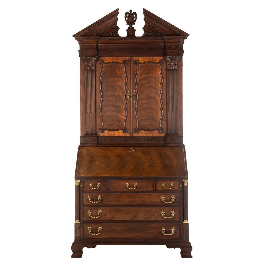 Henkel Harris Mahogany Document Secretary: Circa 1998; Georgian style mahogany desk, with top case having broken arch pediment, double panel doors open to reveal elaborate fitted interior, bottom case with fall front door housing elaborate fit