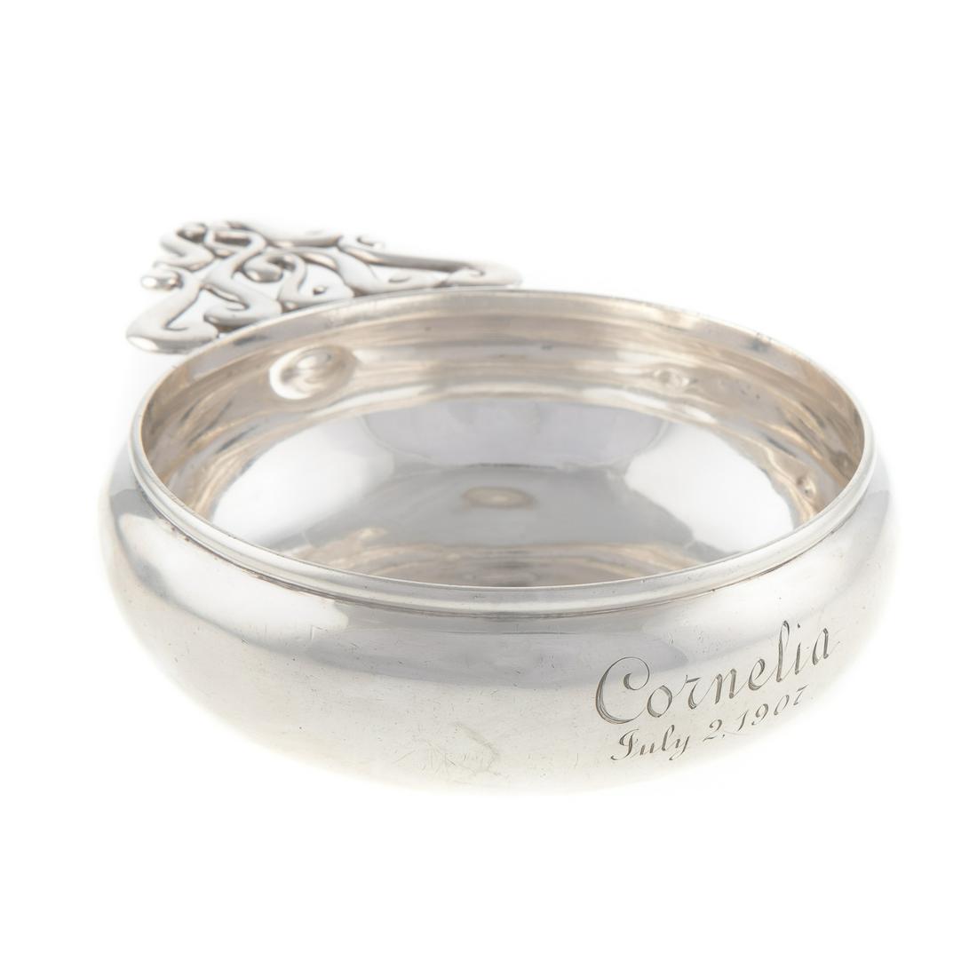 Tiffany & Co. Sterling Porringer: 1902-1907 date mark, pattern# 12755A, 3 gills capacity; circular, with openwork scroll handle, inscribed "Cornelia July 2, 1907," 1 3/4 in. H, 4 1/2 in. Diam., 7 in. L, 7.2 ozt.