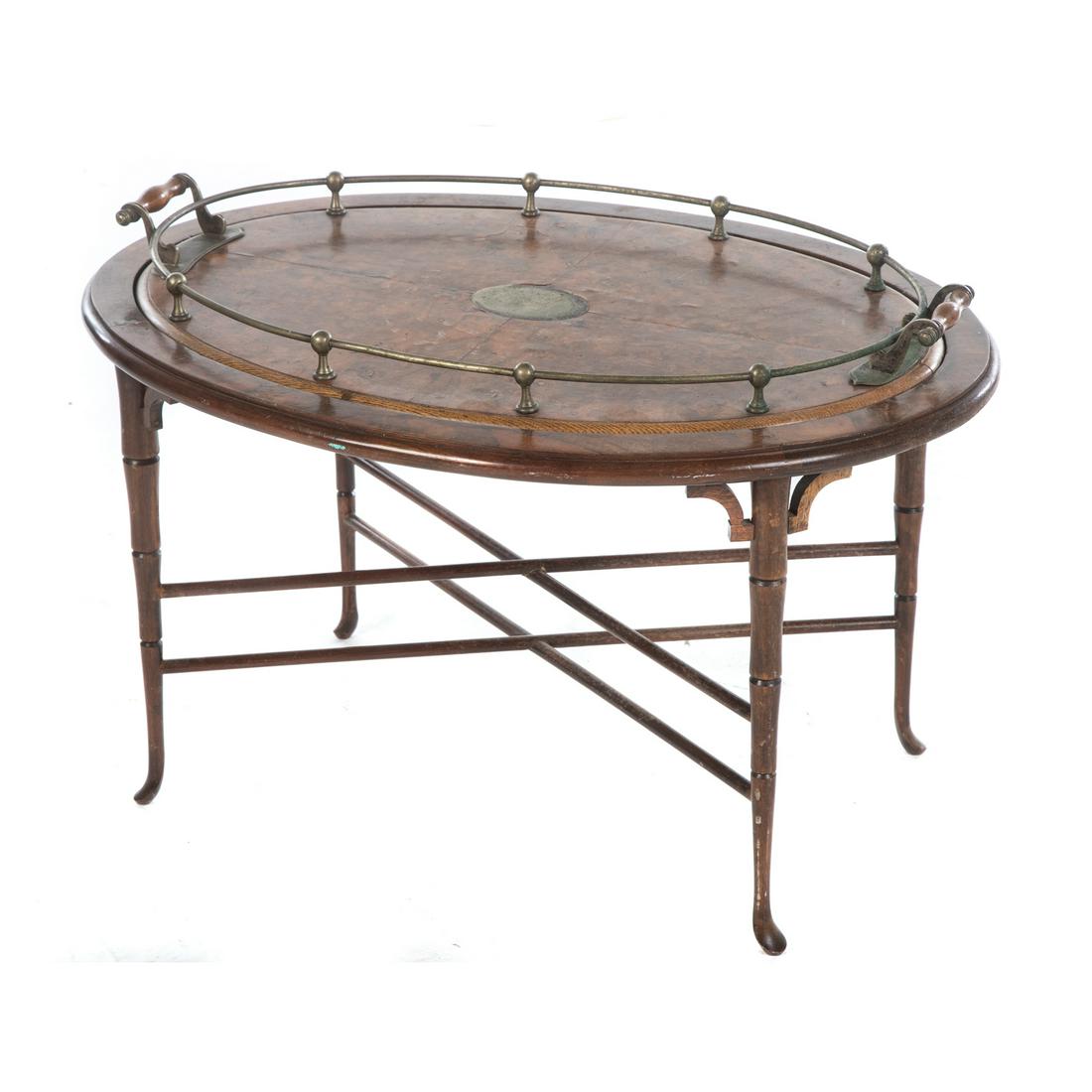 Victorian Burled Wood Butlers Tray Table: With a removable veneered tray top, having a brass gallery, with stretcher base on legs ending in pad feet. 19 in. H., 30 in. W., 21 in. D.
