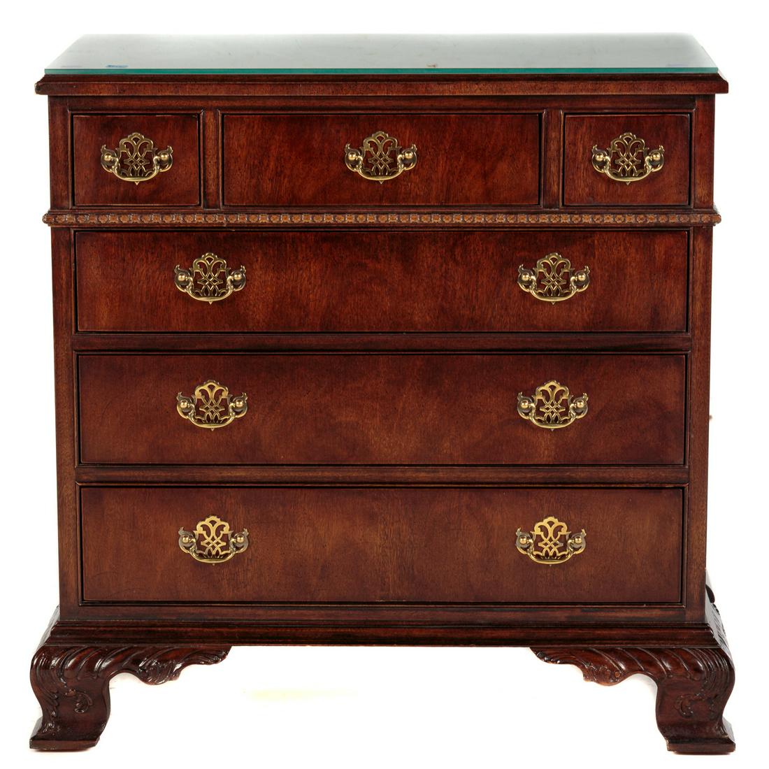 Henredon Mahogany Bachelors Chest: Mahogany with a figural veneered top, having three short drawers over three long drawers, with gadrooning. includes a 1/4 in. glass top. 31 in. H., 33 in. W., 16 in. D.