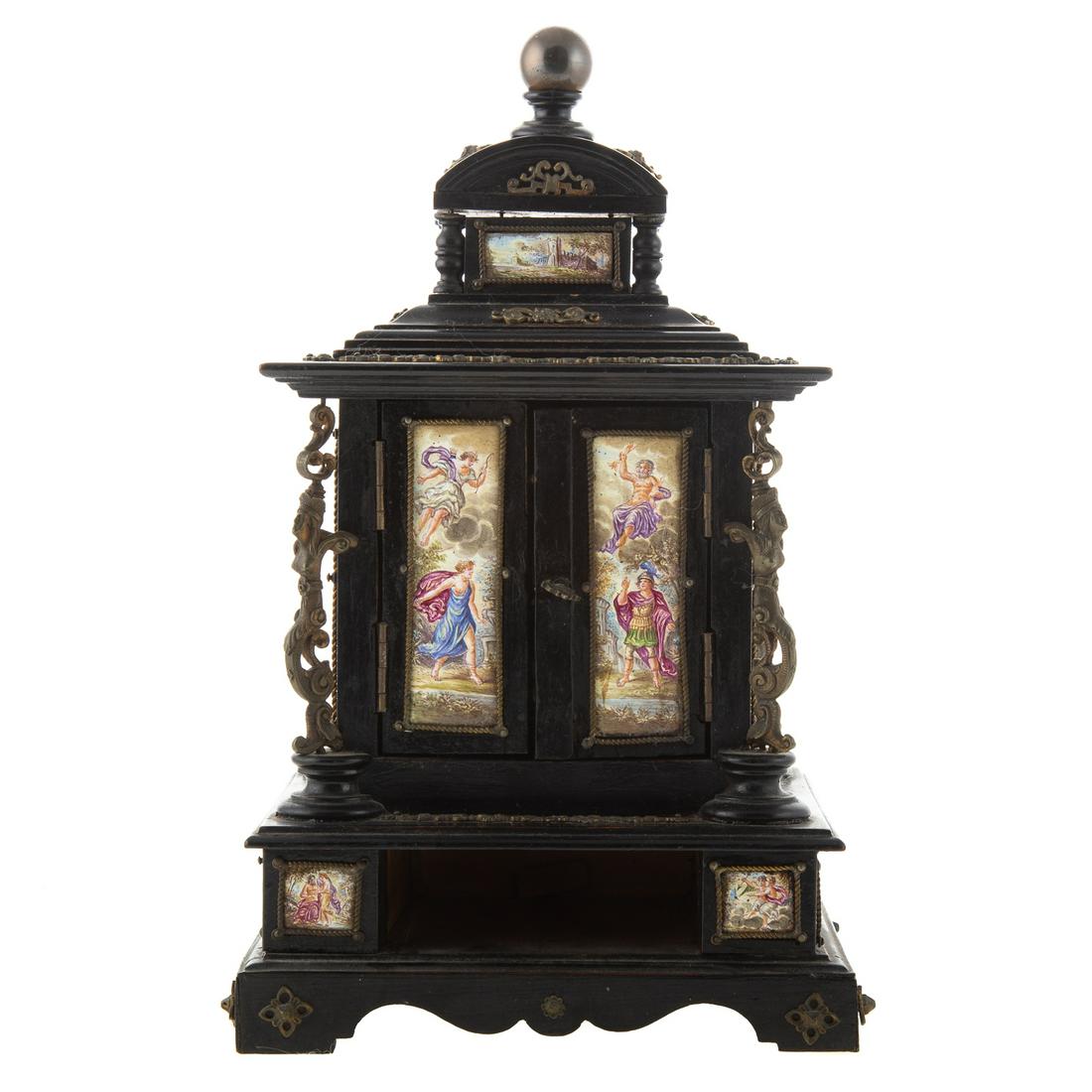 Continental Wood & Enamel Vanity Box: Late 19th century; ebonized wood and gilt metal mounted box with enamel panels depicting mythological scenes, doors open to reveal three small drawers with enamel fronts and interior enamel door panel
