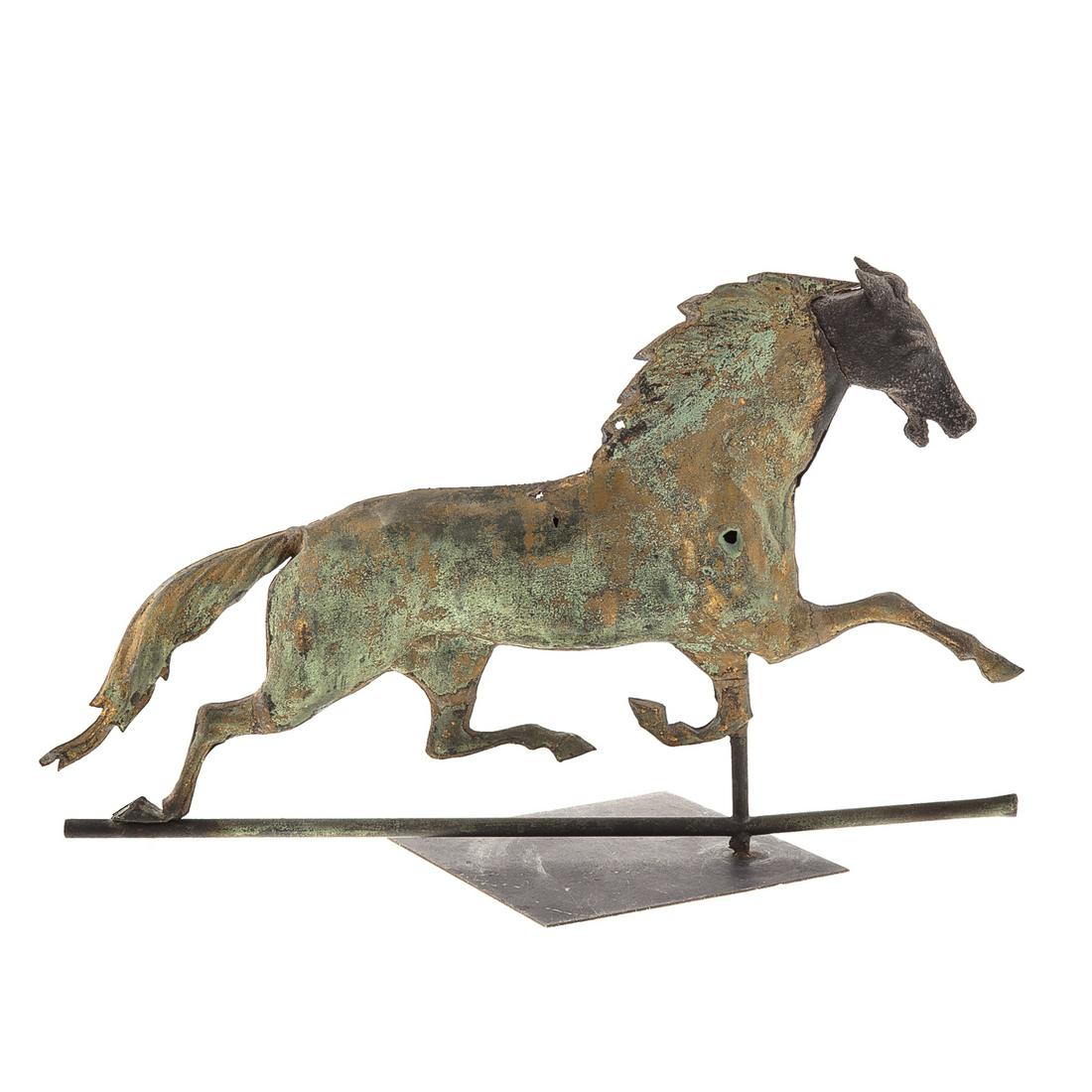 American Trotting Horse Weathervane: Late 19th century; sheet copper body with restored iron head, on directional pole, having traces of gilt 17 in. H., 28 in. L., with removable metal display stand.