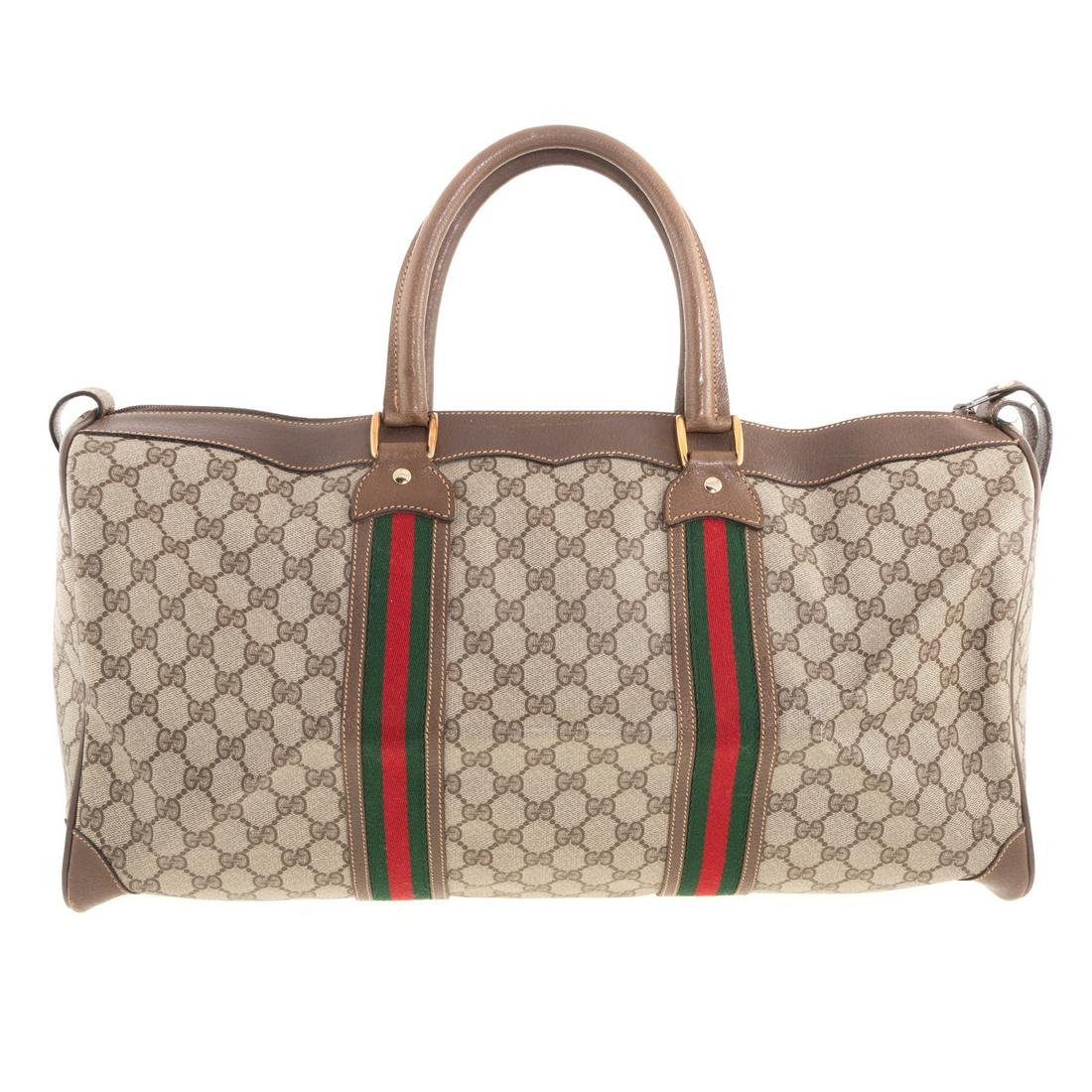 A Gucci Vintage GG Supreme Web Boston Bag: A Monogram Gucci vintage GG Surpreme Web Boston Bag with Web accent, dual rolled leather handles and gold tone hardware. Canvas lining and zip closure at top. Measuring: 6 in. handle drop, 19.5 in. L,