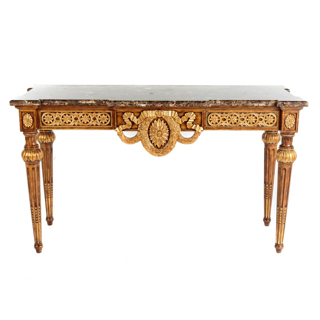 Maitland-Smith Louis XVI Style Marble Top Console: Elaborately carved rosettes and floral swags, with shaped marble top having turret corners, with gilt accents. 36 in. H., 63 in. W., 23 in. D.