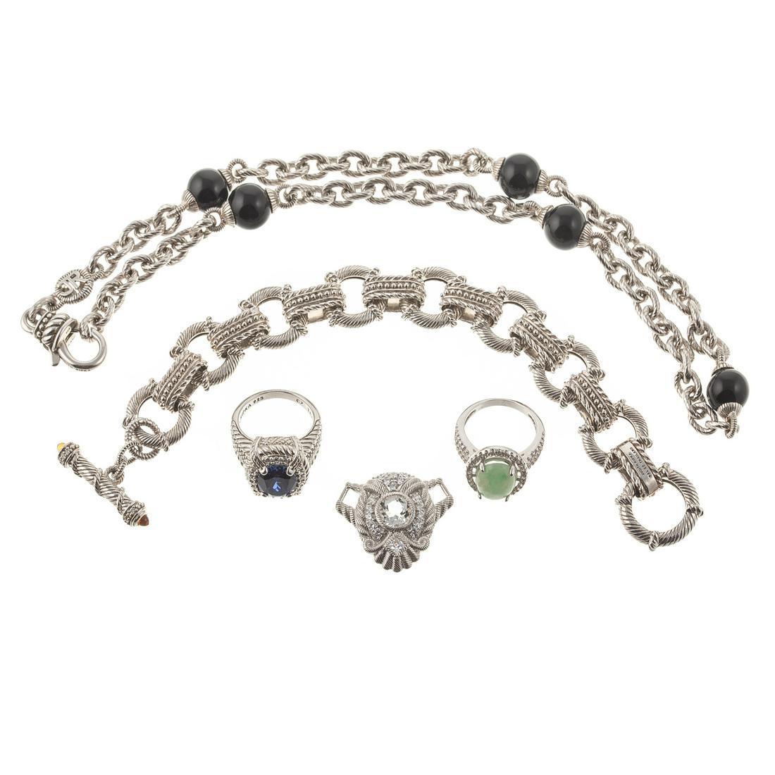 A Collection of Jewelry by Judith Ripka: 1) Sterling silver ring by Judith Ripka featuring an oval cut synthetic blue gemstone set in a textured and twisted rope design, sz. 7.25, 2) sterling silver Judith Ripka pendant featuring a round cut