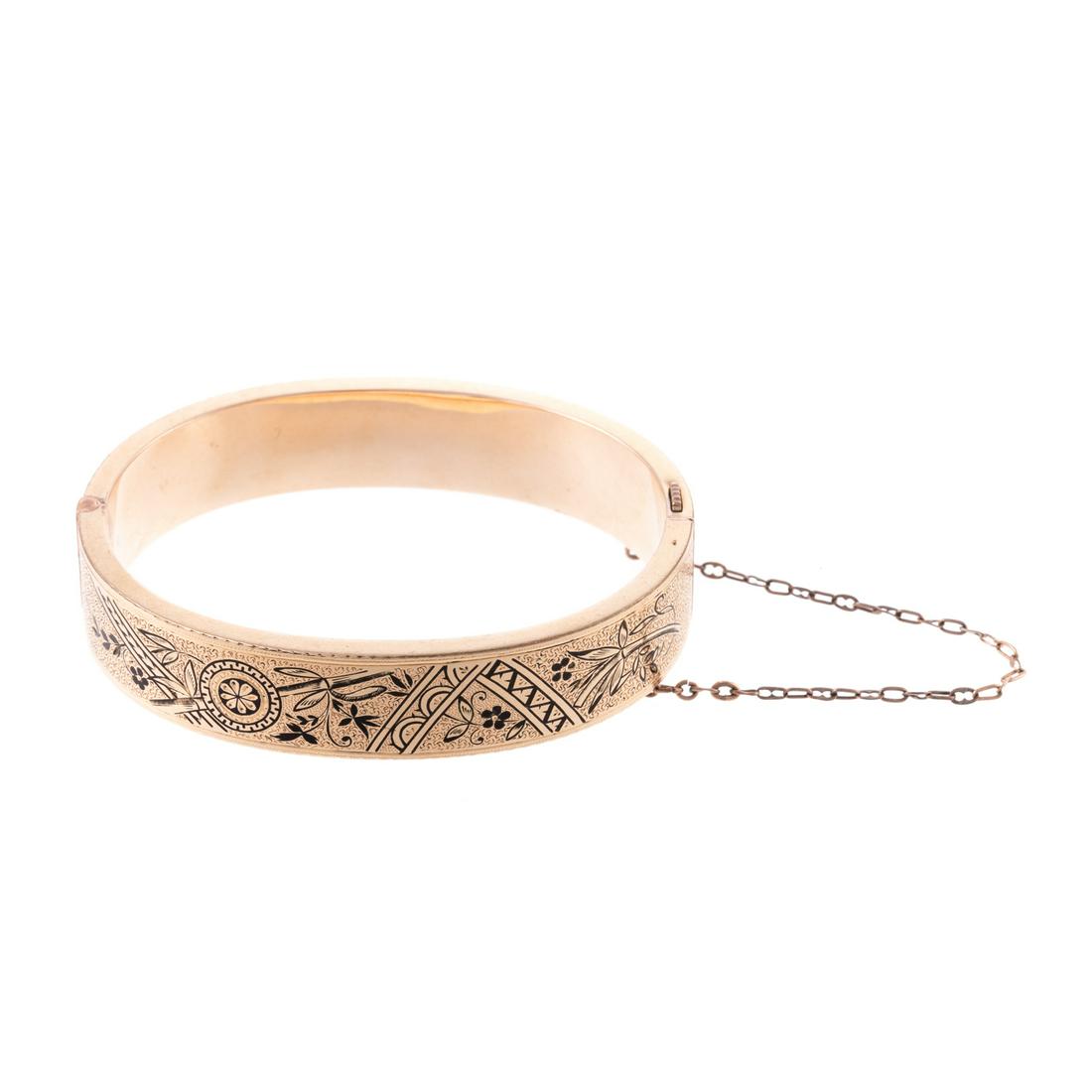 A Victorian 10K Gold Taille d’Epargné Bracelet: 10K yellow gold Victorian black tracery bracelet, 0.50 in. H, 2 in. W, hidden box clasp and safety chain, 18.6 grams