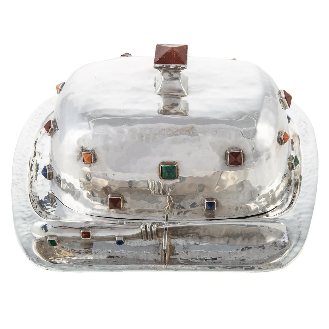 Mexican Inlaid Sterling Covered Butter Dish: Emilia Castillo, Taxco, post-1979; comprising hammered dish, cover and butter knife, with inlaid hardstones including malachite and lapis, and stained wood; dish is 7 1/8 in. L, 6 1/2 in. D, 19.85 ozt