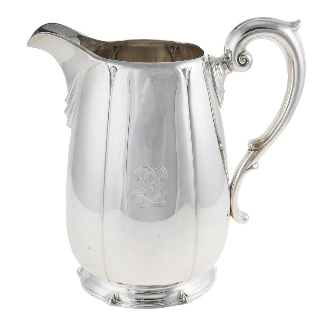 Dominick & Haff Sterling Water Pitcher: Circa 1929, model# 1302/108, 4 1/2 pints capacity; ovoid, in a simple paneled form, conforming foot, foliate capped handle, the spout with draped linen decoration, with LNL monogram for Linda Noe Lain